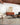 Soft silver and spice-colored Loloi Rugs Axel AXE-02 rug displayed in a cozy living room scene.