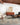 Beige and sky blue Loloi Rugs Axel AXE-03 rug displayed on a wooden floor with a broom nearby.
