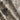 Grey and slate Loloi Rugs Elixir EH-02 rug with intricate pattern, shown lying on a wooden floor in a cozy living room setting.