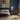 Grey and peridot Loloi Rugs Elixir EH-07 rug with intricate pattern, shown on a wooden floor in a cozy living space.