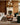 Loloi Rugs Heritage HER-01 CLAY/NATURAL rug with intricate patterns and soft texture, shown on a wooden floor in a cozy room.