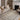 Beige and midnight Loloi Rugs Wade WAE-05 area rug shown in a cozy room setting with furniture and decor.