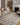 Beige and midnight Loloi Rugs Wade WAE-05 area rug shown in a cozy room setting with furniture and decor.