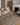 Wade Loloi Rugs WAE-05 brown and stone woven rug displayed in a stylish living room setting.