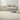 Nourison Billows BIL01 ivory beige rug displayed in a cozy living room setting.