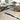 Round Nourison Christopher Guy Wool and Silk Rug CGS11 Sea Sand with soft, textured beige and sandy tones.