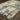 Indoor rug by Oriental Weavers, Evolution 8027A, with intricate pattern in neutral tones, measuring 10x3.2 feet.