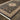 Indoor rug by Oriental Weavers, Masterpiece 33B, with intricate patterns in neutral tones, measuring 2-3 x 10 feet.